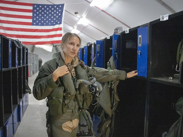 U.S. Air Force Capt. Emily Thompson, 421st Expeditionary Fighter Squadron pilot, dons flight equipment at the Aircrew Flight Equipment shop on Al Dhafra Air Base, United Arab Emirates, June 5, 2020. Thompson is the first female to fly an F-35A Lightning II into combat. She is currently deployed from Hill …