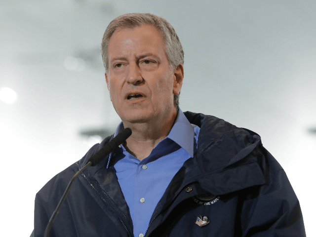 In this March 31, 2020, file photo, New York City Mayor Bill de Blasio speaks at the USTA Indoor Training Center where a 350-bed temporary hospital will be built to support efforts in fight against COVID-19 in New York. De Blasio says on Wednesday, May 20, the city will offer …