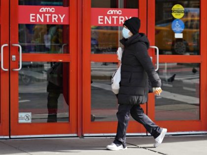 NEW YORK, NY - MARCH 16: A person wears a protective mask while walking by an AMC movie theater as the coronavirus continues to spread across the United States on March 16, 2020 in New York City. The World Health Organization declared coronavirus (COVID-19) a global pandemic on March 11th. …