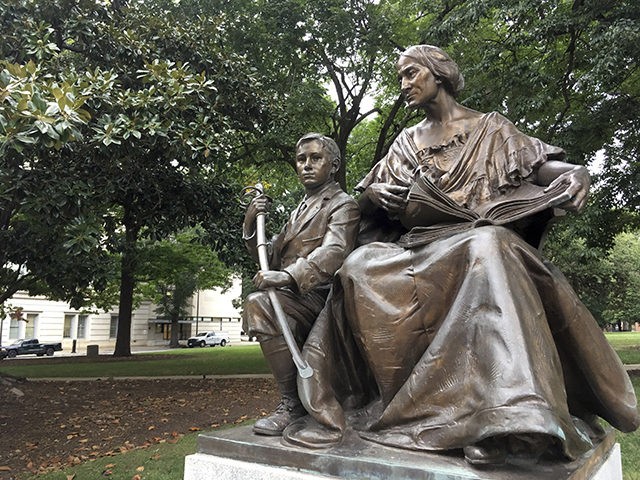 A monument inscribed "To the North Carolina Women of the Confederacy" is seen on Thursday, Aug. 17, 2017 on the grounds of the old State Capitol in Raleigh, N.C. The 7-foot-tall monument of a woman and young boy is made of bronze and granite, and it was dedicated in 1914. …