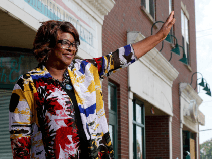 Mayor-elect Ella Jones waves to a supporter passing by while posing for a photo Wednesday, June 3, 2020, in Ferguson, Mo. Jones, currently a city council member who was elected mayor on Tuesday, will become the first black and first woman mayor of the city thrust into the national spotlight …