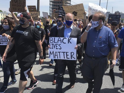 CORRECTS BYLINE TO MARK SCOLFORO - Gov. Tom Wolf, holds a "black lives matter" sign while walking alongside Harrisburg Mayor Eric Papenfuse, right, marches with demonstrators protesting police violence against black people and racial injustice following the killing of George Floyd, Wednesday, June 3, 2020 in Harrisburg, Pa. (AP Photo/Mark …