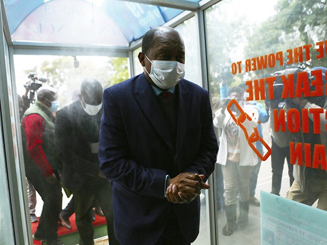 Zimbabwe's Health minister, Obadiah Moyo, arrives at court in Harare, Saturday June 20, 2020. Moyo is facing allegations of illegally awarding a multi- million dollar contract for COVID-19 testing kits, drugs and personal protective equipment to a shadowy company. (AP Photo/Tsvangirayi Mukwazhi)