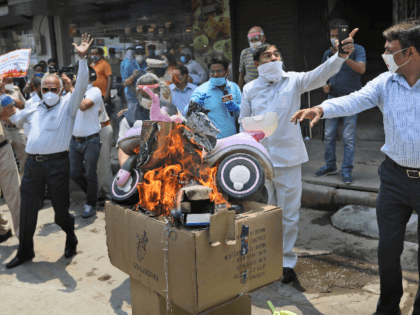 Indian traders burn Chinese products and a poster president Xi Jinping during a protest in New Delhi, India, Monday, June 22, 2020. China said the Galwan Valley high up in the Himalayan border region where Chinese and Indian troops engaged in a deadly brawl this week falls entirely within China, …