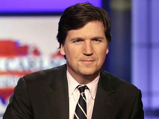 Tucker Carlson, host of "Tucker Carlson Tonight," poses for photos in a Fox News Channel studio, in New York, Thursday, March 2, 2107. (AP Photo/Richard Drew)