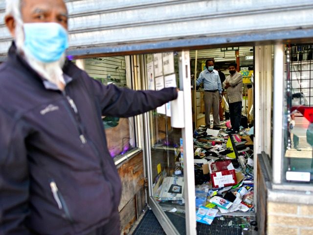 PHILADELPHIA, PA - JUNE 01: Shop owners survey the damage to their store in the aftermath