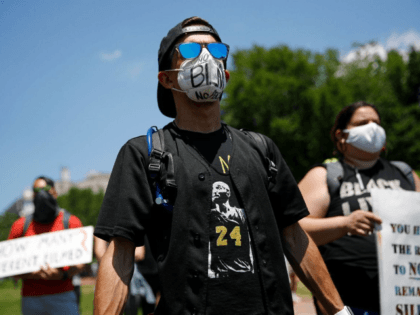 Protesters wear face masks to protect against the spread of the new coronavirus as they gather in Lafayette Square, Saturday, June 13, 2020, near the White House in Washington, while demonstrating against the death of George Floyd. (AP Photo/Patrick Semansky)