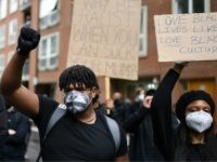 Protesters hold placards as they attend a demonstration in central London on June 6, 2020, to show solidarity with the Black Lives Matter movement in the wake of the killing of George Floyd, an unarmed black man who died after a police officer knelt on his neck in Minneapolis. - …
