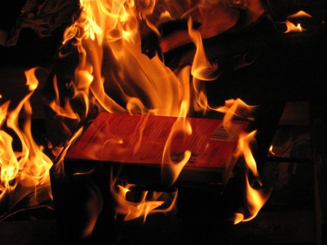 Book burning (pcorreia / Flickr / CC / Cropped)