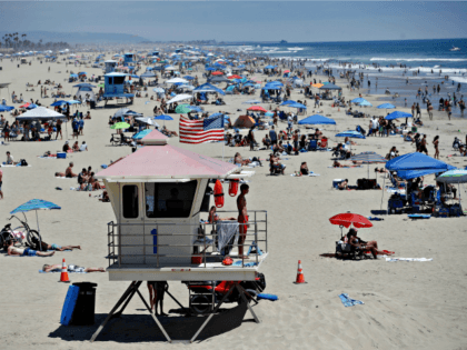In this June 27, 2020, file photo, a lifeguard keeps watch over a packed beach in Huntingt