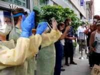 healthcare workers cheer for crowds