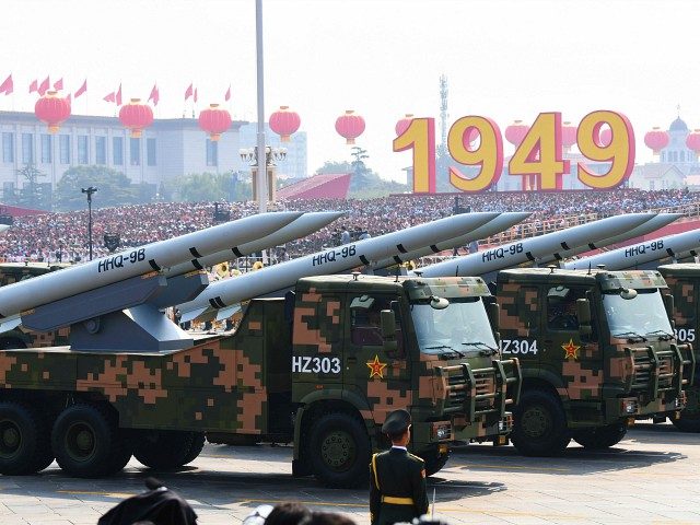 Military vehicles carrying HHQ-9B surface-to-air missiles participate in a military parade