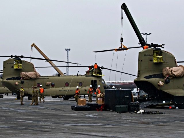 U.S. Technicians prepare helicopters for the transport in Bremerhaven, northern Germany, Sunday Feb. 12, 2017. The U.S. Army has begun unloading dozens of Chinook, Apache and Black Hawk helicopters at the northern German port of Bremerhaven, to be moved to the Bavarian town of Illesheim, Germany. Some of them will …