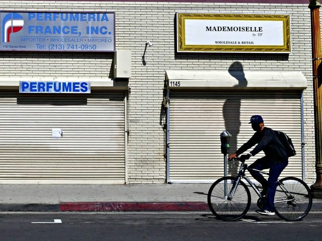 Closed shopfronts in what would be a normally busy fashion district in Los Angeles, Califo