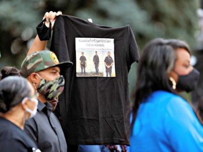 A supporter holds up a shirt to call attention to the death of Elijah McClain (Photo: AP Photo/David Zalubowski)