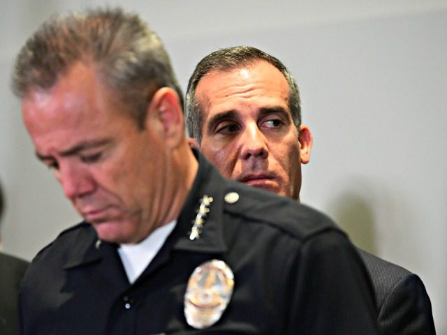 Los Angeles Mayor Eric Garcetti looks on as police chief Michael Moore addresses the media at Los Angeles Police Department Headquarters on April 2, 2019 in Los Angeles, California as they name a suspect in the murder of Rapper Nipsey Hussle. - Grammy-nominated rapper Nipsey Hussle was shot dead in …