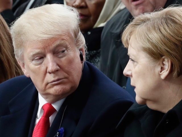 TOPSHOT - US President Donald Trump (L) and German Chancellor Angela Merkel (R) speak as they attend a ceremony at the Arc de Triomphe in Paris on November 11, 2018 as part of commemorations marking the 100th anniversary of the 11 November 1918 armistice, ending World War I. (Photo by …