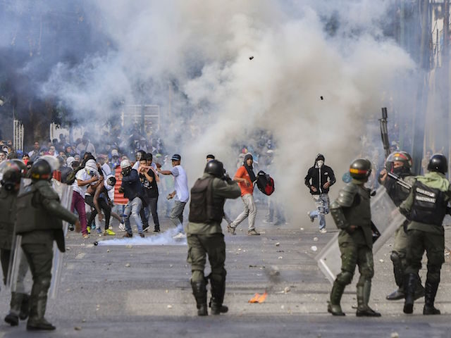 TOPSHOT - Riot police clash with opposition demonstrators during a protest against the gov