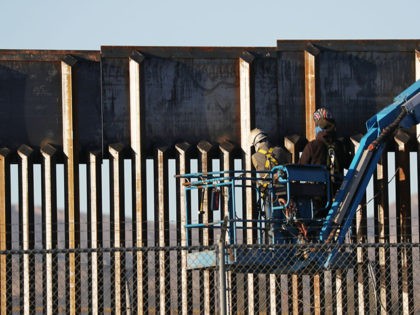 EL PASO, TEXAS - FEBRUARY 12: People work on the U.S./ Mexican border wall on February 12,