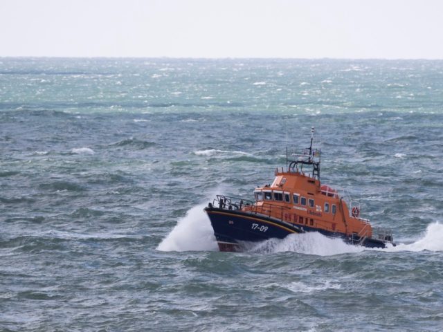 DOVER, ENGLAND - APRIL 04: An RNLI vessel makes it's way along the coastline near Samphire