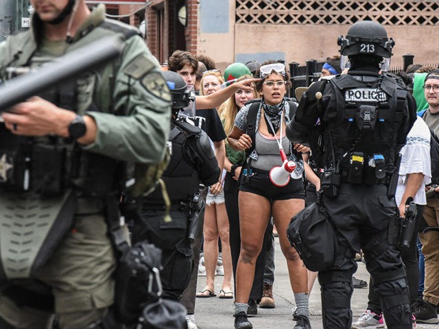 PORTLAND, OR - AUGUST 17: A woman looks at the police during an alt-right rally on August 17, 2019 in Portland, Oregon. Anti-fascism demonstrators gathered to counter-protest a rally held by far-right, extremist groups. (Photo by Stephanie Keith/Getty Images)