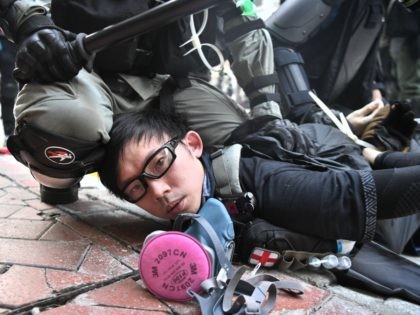 TOPSHOT - A protester is detained by police as violent demonstrations take place in the streets of Hong Kong on October 1, 2019, as the city observes the National Day holiday to mark the 70th anniversary of communist China's founding. - Police fanned out across Hong Kong on October 1 …