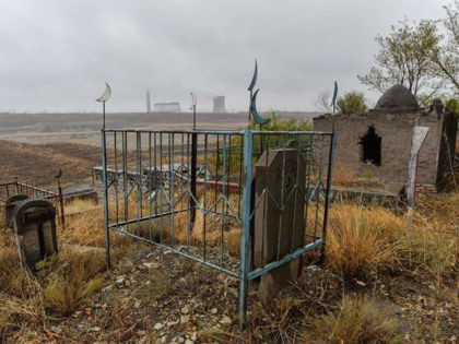 This photo taken on September 10, 2019 shows a general view of a large Muslim cemetery on the outskirts of Urumqi, the regional capital of Xinjiang. - China is destroying burial grounds where generations of Uighur families have been laid to rest, leaving behind human bones and broken tombs in …