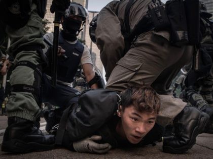 HONG KONG, CHINA - SEPTEMBER 29: A pro-democracy protester is tackled and arrested by poli