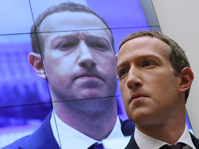 WASHINGTON, DC - OCTOBER 23: With an image of himself on a screen in the background, Facebook co-founder and CEO Mark Zuckerberg testifies before the House Financial Services Committee in the Rayburn House Office Building on Capitol Hill October 23, 2019 in Washington, DC. Zuckerberg testified about Facebook's proposed cryptocurrency …