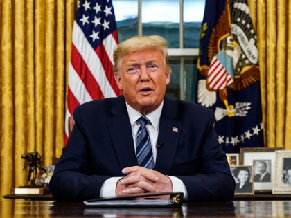 TOPSHOT - US President Donald Trump addresses the Nation from the Oval Office about the widening novel coronavirus (Covid-19) crisis in Washington, DC on March 11, 2020. - President Donald Trump announced on March 11, 2020 the United States would ban all travel from Europe for 30 days starting to …