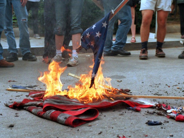 (FILES): This 20 April 2002 file photo shows demonstrators burning US flags in front of the World Bank headquarters during a protest against the International Monetary Fund - World Bank spring meetings in Washington, DC. The US Senate began debate 26 June 2006 on a constitutional amendment banning destruction and …