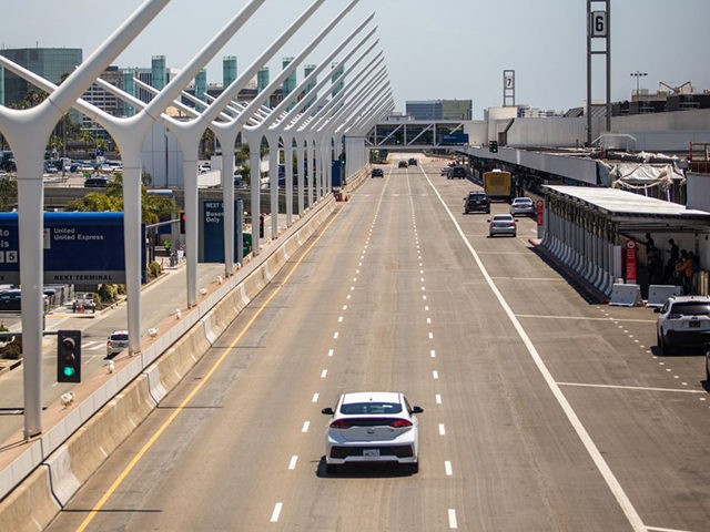 A car drives past the departure terminal at LAX airport at the start of the Memorial Day holiday weekend during the novel coronavirus, COVID-19, pandemic in Los Angeles, California on May 22, 2020. - "Last year, 43 million Americans traveled for Memorial Day Weekend the second-highest travel volume on record …