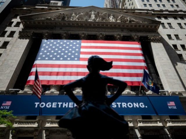 The New York Stock Exchange (NYSE) is pictures on May 26, 2020 at Wall Street in New York City. - Wall Street stocks surged early Tuesday on optimism about coronavirus vaccines as the New York Stock Exchange resumed physical floor trading for the first time since late March. About 30 …