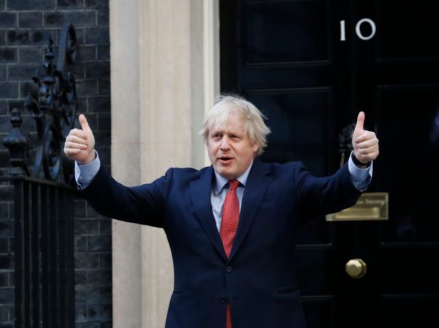 Britain's Prime Minister Boris Johnson participates in a national "clap for carers" to show thanks for the work of Britain's NHS (National Health Service) workers and other frontline medical staff around the country as they battle with the novel coronavirus pandemic, outside 10 Downing Street in London on May 28, …