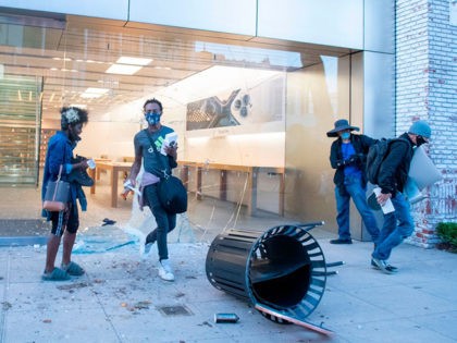 People are seen looting the Apple store at the Grove shopping center in the Fairfax District of Los Angeles on May 30, 2020 following a protest against the death of George Floyd, an unarmed black man who died while while being arrested and pinned to the ground by the knee …