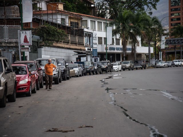 CARACAS, VENEZUELA - JUNE 01: A long line of cars awaiting to put gas in an international prices gas station on June 1, 2020 in Caracas, Venezuela. After 77 days, Maduro Administration eases the restrictions against COVID-19, allowing certain activities to reopen. From today, an official limit has been set …
