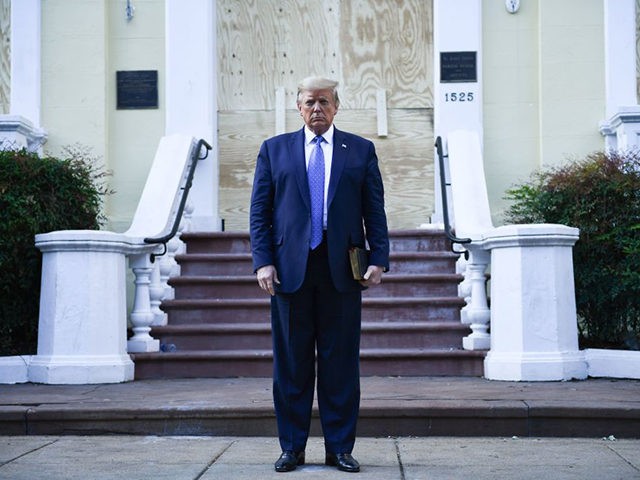 US President Donald Trump holds up a bible in front of boarded up St John's Episcopal church after walking across Lafayette Park from the White House in Washington, DC on June 1, 2020. - US President Donald Trump was due to make a televised address to the nation on Monday …