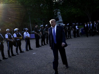 US President Donald Trump walks back to the White House escorted by the Secret Service after appearing outside of St John's Episcopal church across Lafayette Park in Washington, DC on June 1, 2020. - US President Donald Trump was due to make a televised address to the nation on Monday …
