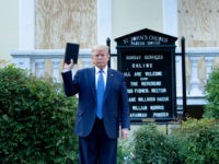 TOPSHOT - US President Donald Trump holds a Bible while visiting St. John's Church across from the White House after the area was cleared of people protesting the death of George Floyd June 1, 2020, in Washington, DC. - US President Donald Trump was due to make a televised address to the nation on Monday after days of anti-racism protests against police brutality that have erupted into violence.