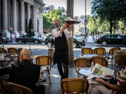 A waiter works at the terrasse of a restaurant in Paris on June 2, 2020, as cafes and rest