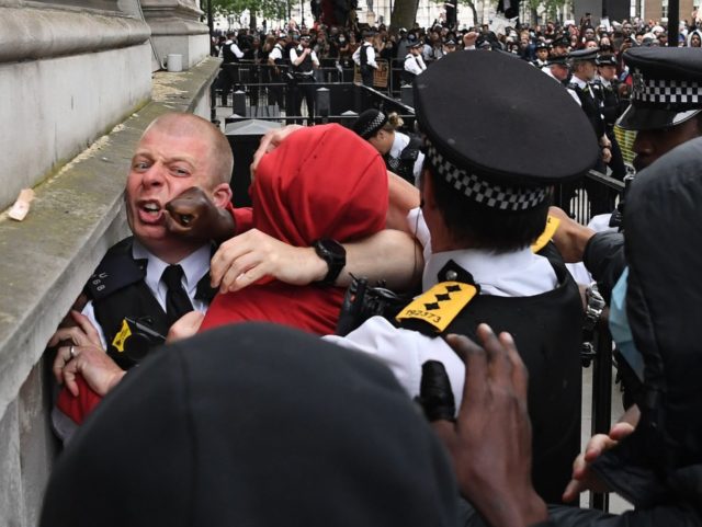 Police officers scuffle with a protestor near the entrance to Downing Street, during an anti-racism demonstration in London, on June 3, 2020, after George Floyd, an unarmed black man died after a police officer knelt on his neck during an arrest in Minneapolis, USA. - Londoners defied coronavirus restrictions and …