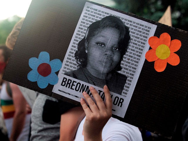 A demonstrator holds a sign with the image of Breonna Taylor, a black woman who was fatally shot by Louisville Metro Police Department officers, during a protest against the death George Floyd in Minneapolis, in Denver, Colorado on June 3, 2020. - US protesters welcomed new charges brought Wednesday against …
