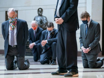WASHINGTON, DC - JUNE 04: Senate Democrats, including Sen. Tim Kaine (D-VA), Sen. Michael Bennet (D-CO), take a knee as they participate in a moment of silence to honor George Floyd and the Black Lives Matter movement in Emancipation Hall of the U.S. Capitol on June 4, 2020 in Washington, …