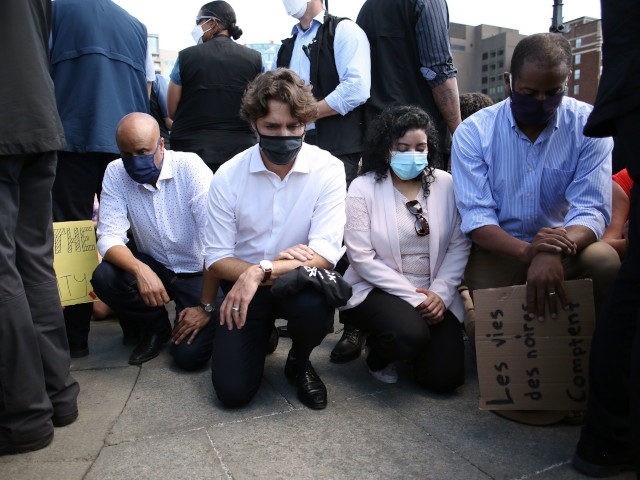 Canadian Prime Minister Justin Trudeau (2nd L) takes a knee during in a Black Lives Matter