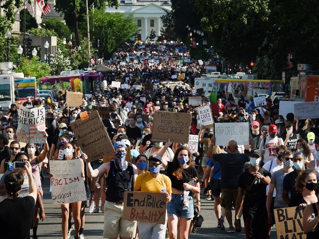 Protesters march near the White House during a demonstration against racism and police brutality, in Washington, DC on June 6, 2020. - Demonstrations are being held across the US following the death of George Floyd on May 25, 2020, while being arrested in Minneapolis, Minnesota. (Photo by Olivier DOULIERY / …