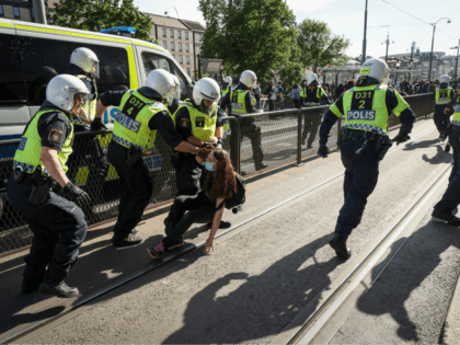 Police detain a protester during a anti-racism demonstration on June 7, 2020 in Gothenburg, Sweden, in solidarity with protests raging across the US over the death of George Floyd, an unarmed black man who died during an arrest on May 25. (Photo by Adam IHSE / TT News Agency / …
