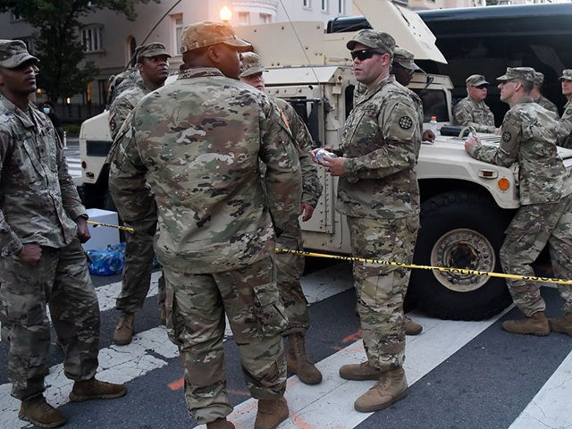 Members of the US National Guard stand near the White House as people protest against raci
