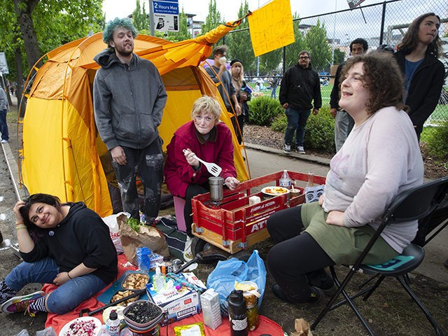 SEATTLE, WA - JUNE 12: A group of friends (L-R) Azzy Grey, Klaire Lee, Onyx Nelson and Samara Isley make food they offer for free with produce they got for free in an area dubbed the Capitol Hill Autonomous Zone (CHAZ) on June 12, 2020 in Seattle, Washington. The area …