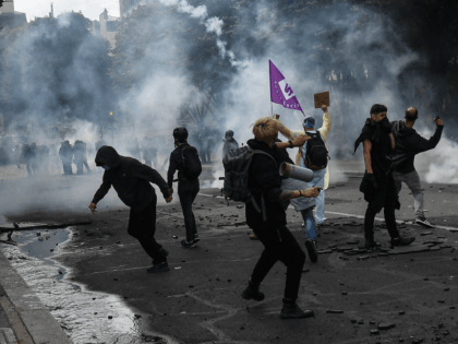 TOPSHOT - Protesters clash with police on the Invalides esplanade during a demonstration in Paris, on June 16, 2020, as part of a nationwide day of protests to demand better working conditions for health workers. (Photo by Alain JOCARD / AFP) (Photo by ALAIN JOCARD/AFP via Getty Images)