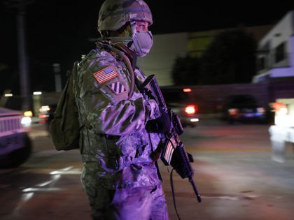 SANTA MONICA, CALIFORNIA - MAY 31: A U.S. National Guard soldier walks on patrol in the aftermath of George Floyd’s death after looting occurred in the area amid demonstrations on May 31, 2020 in Santa Monica, California. California Governor Gavin Newsom has deployed National Guard troops to Los Angeles County …
